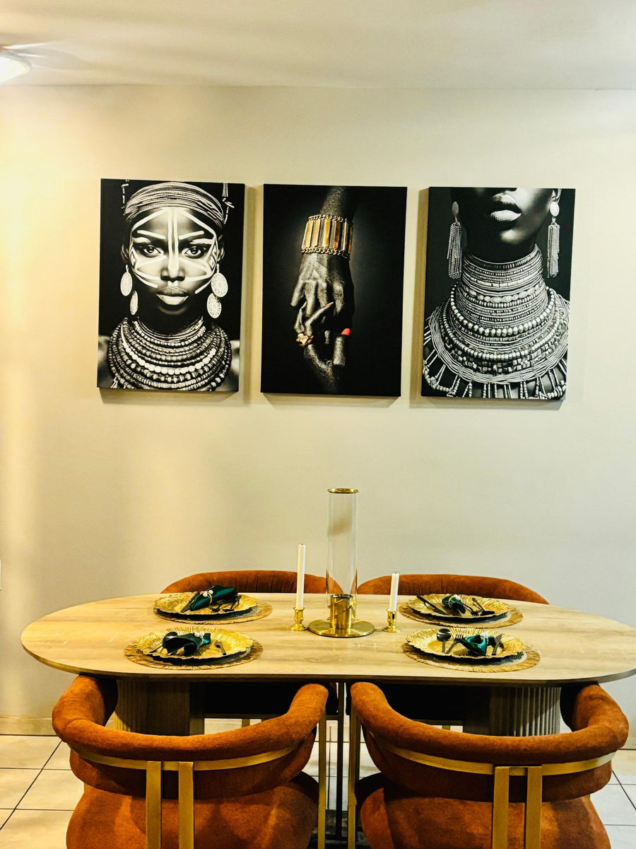 Black-and-white 3-piece canvas set above a dining table