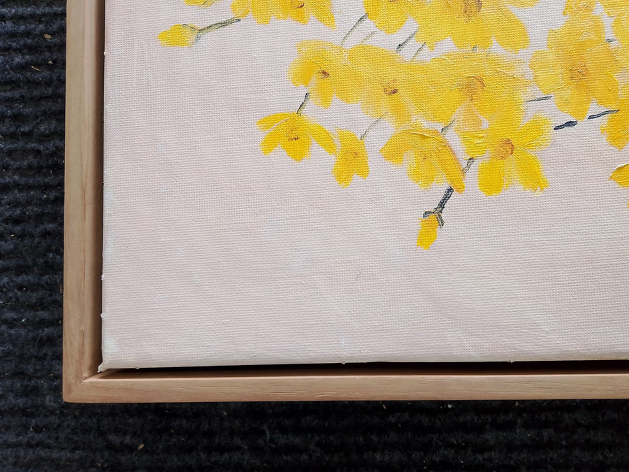 Yellow blossom artwork in a natural wood frame