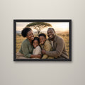 Family photo framed canvas print in a black frame on a wall