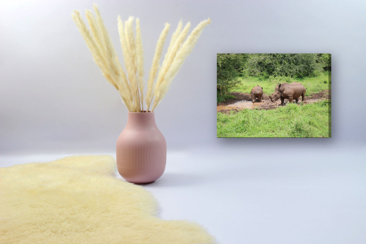 Rhinos at the Mud Wallow by Mark Isaacs canvas print in a styled corner